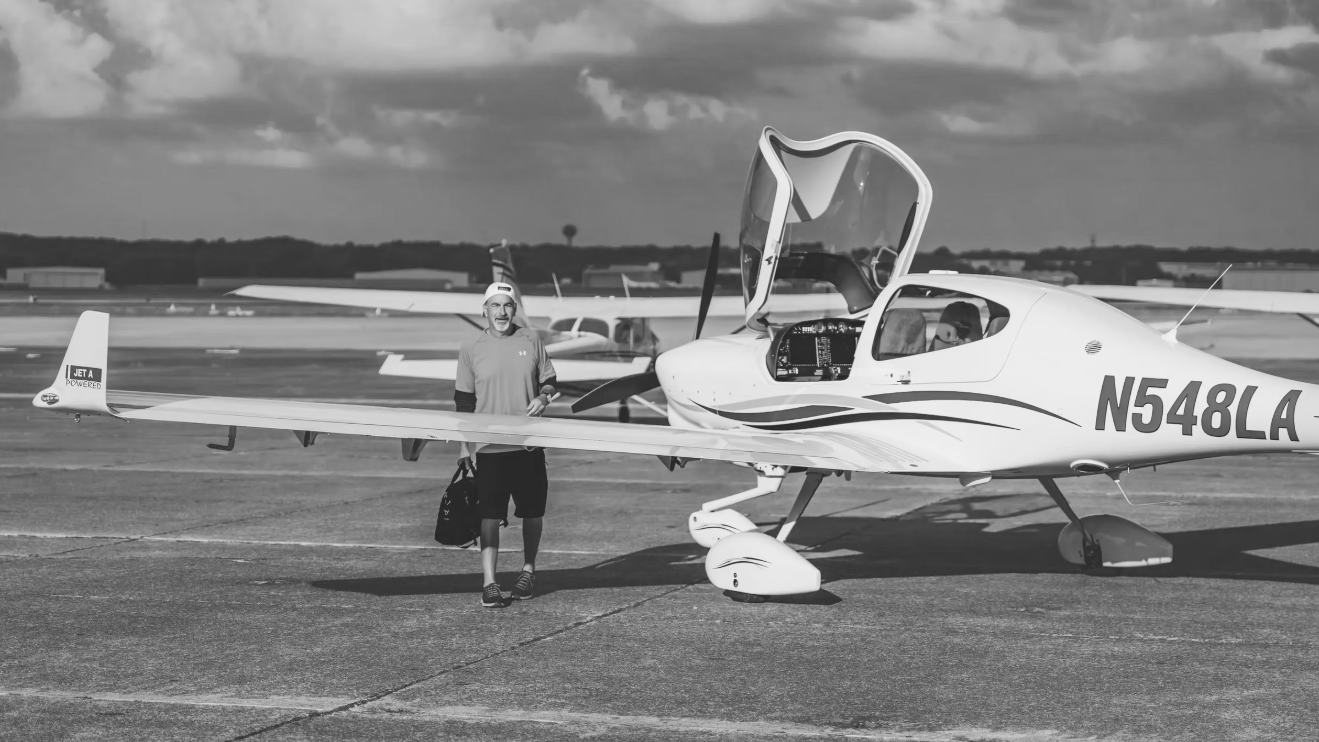 Sean Amos, owner of Flying High Again, on the ramp with a Diamond aircraft